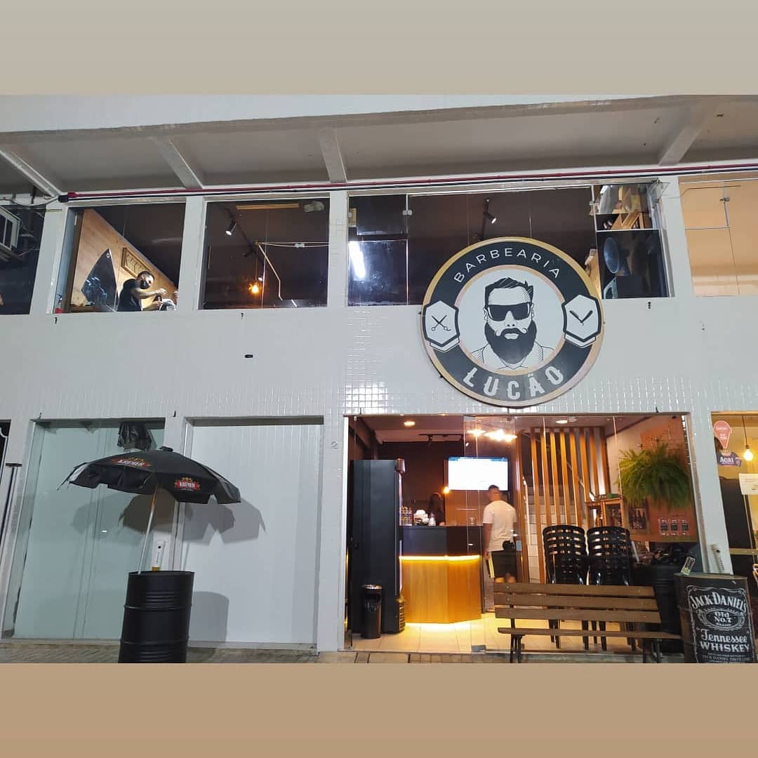 Fachada da Barbearia Lucão à noite, no Boqueirão, Curitiba